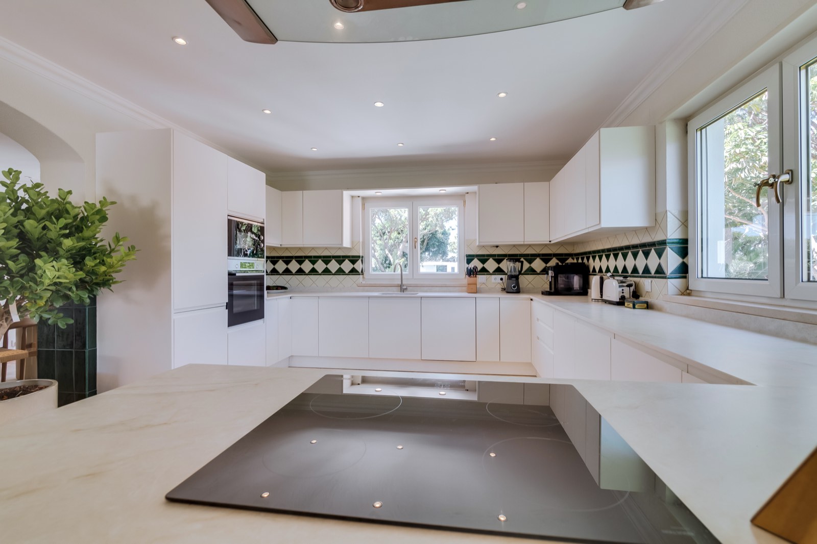 Bright kitchen with stone island and garden windows