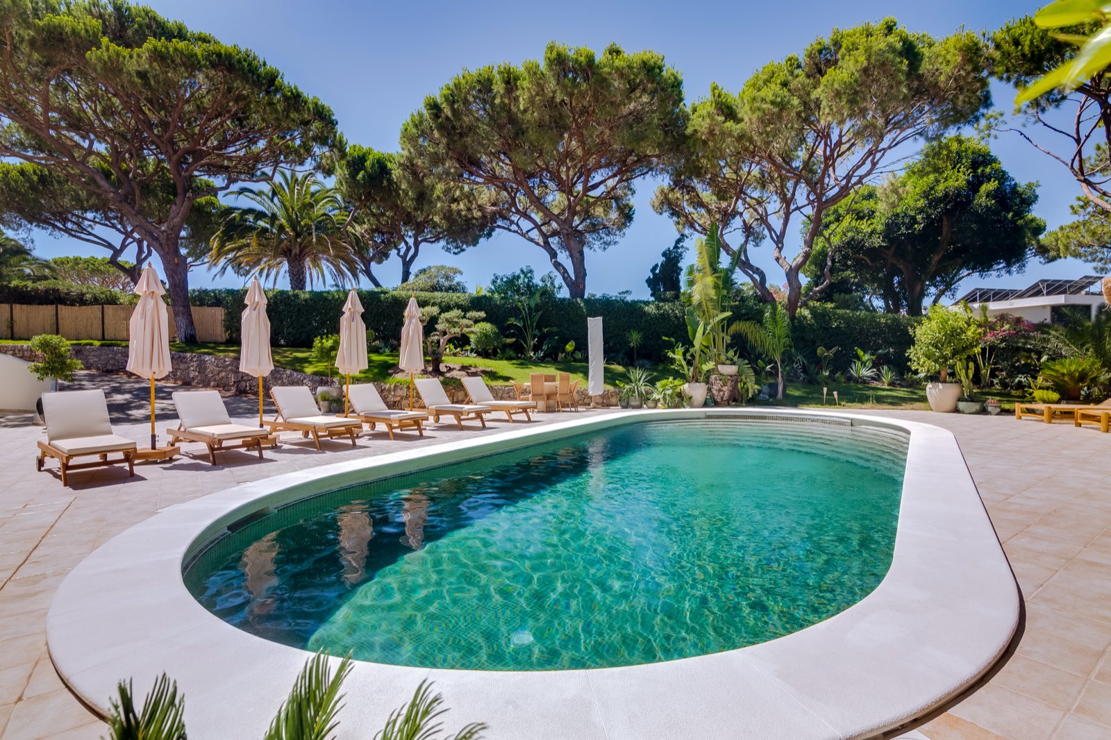 Sunlight over the still water of the pool at Casa da Fortuna