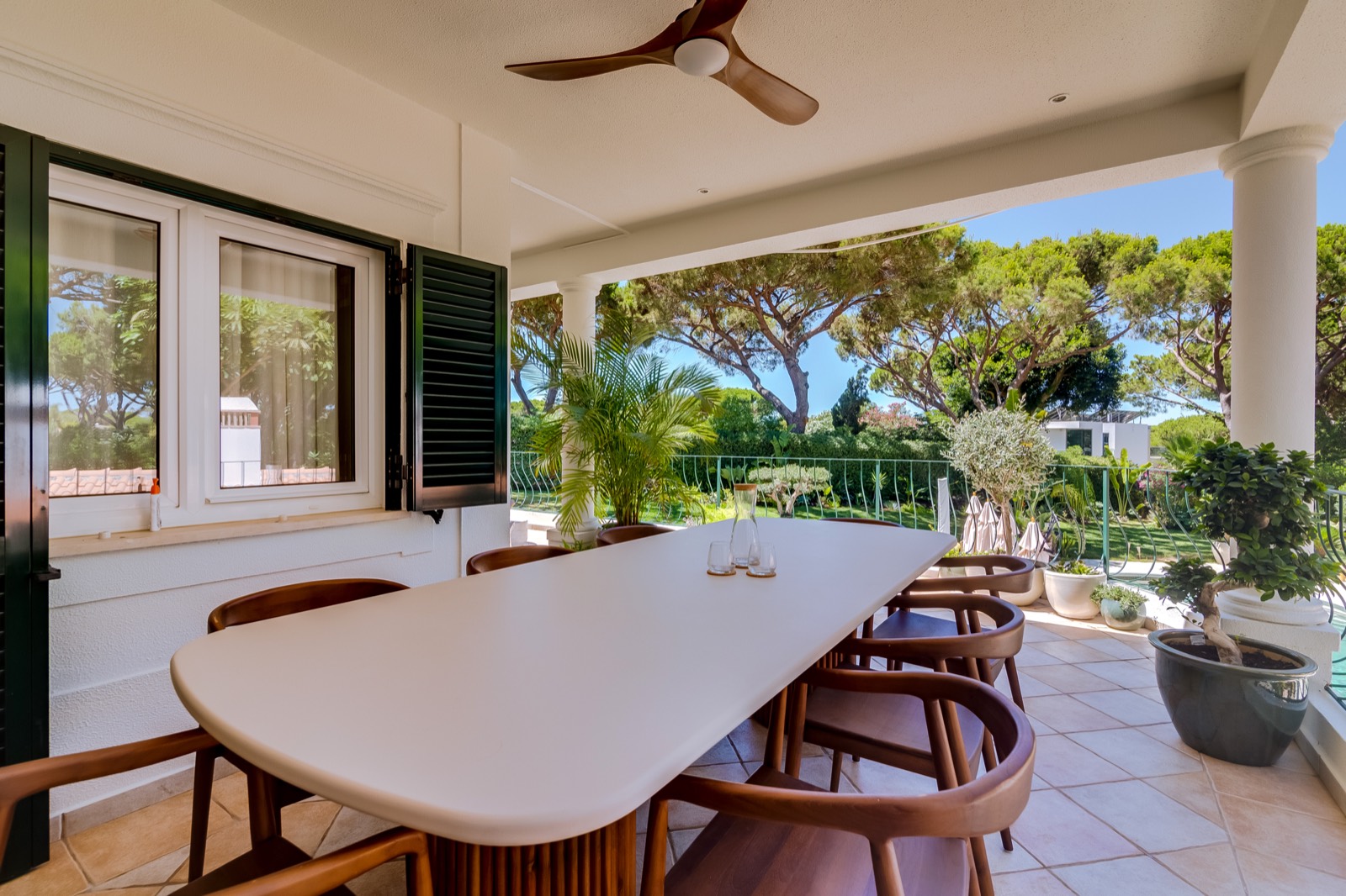 Covered terrace dining area beside the garden