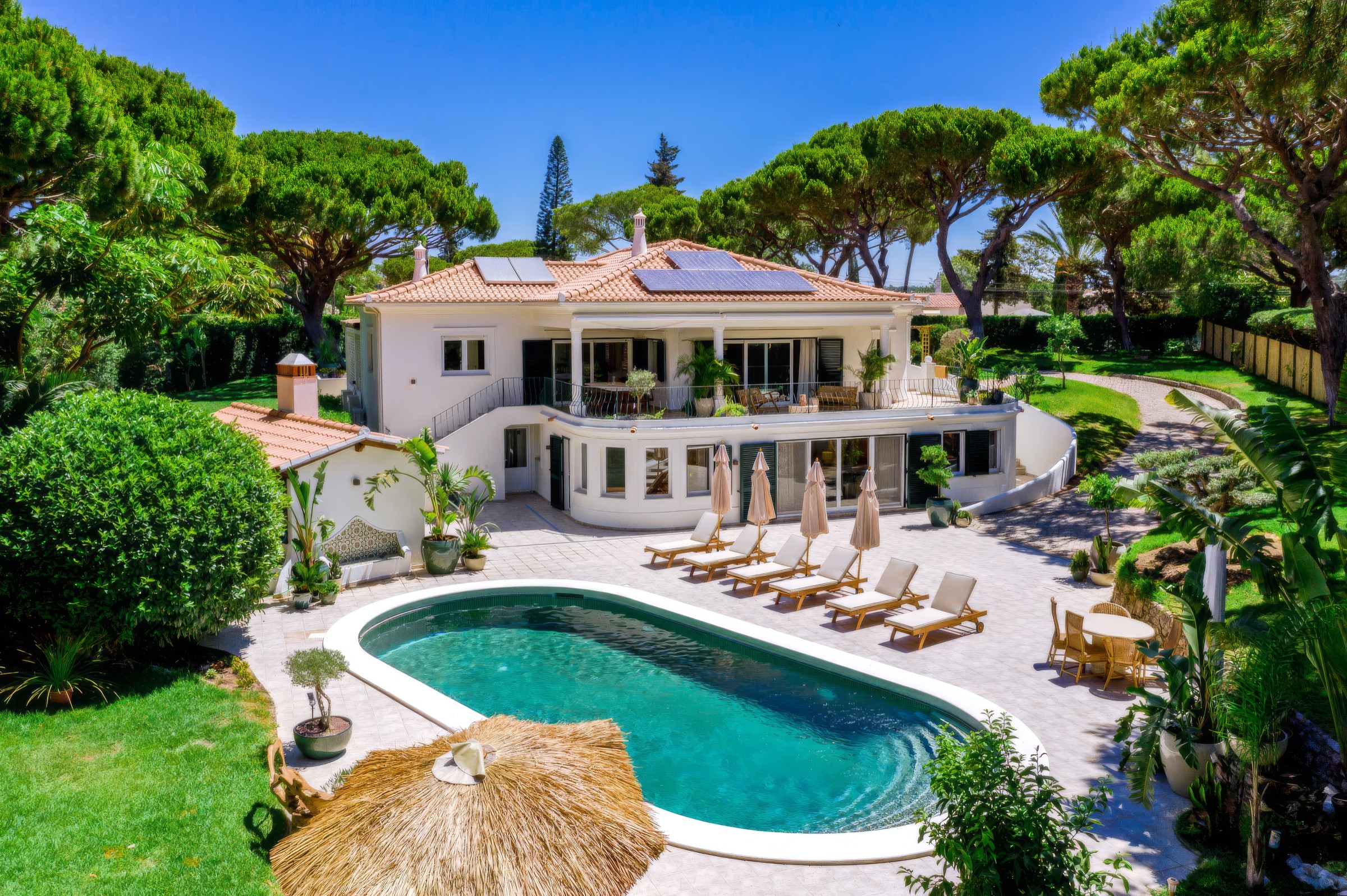 Aerial view of the white villa, its oval pool and the surrounding umbrella pines at Casa da Fortuna, Fonte Santa, Algarve
